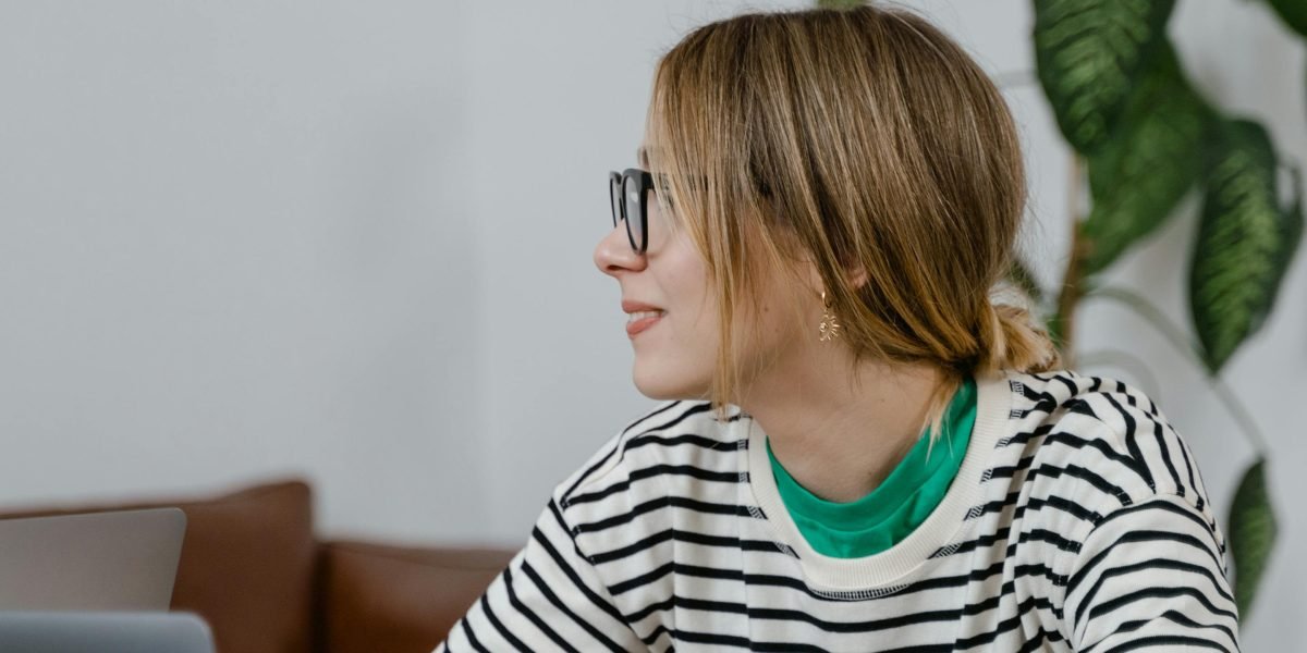 An individual focused on learning new concepts, diligently taking notes and studying to enhance their skills.