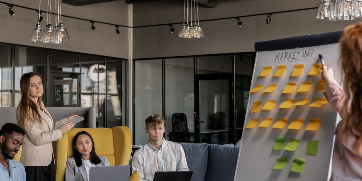 Marketing professionals engaging in a lively discussion, strategizing how to apply AI insights.