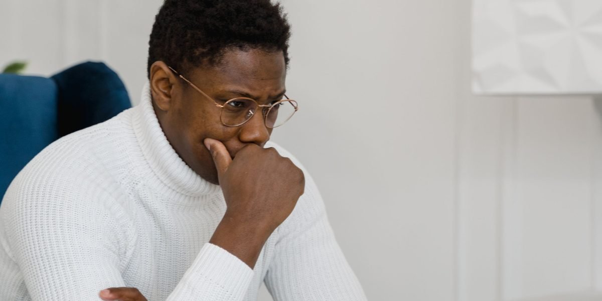 A person thoughtfully processing information, symbolizing the challenge of discerning valuable insights from vast amounts of news.
