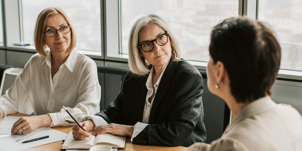 A diverse business team engaged in a serious discussion, emphasizing trust and ethical considerations.