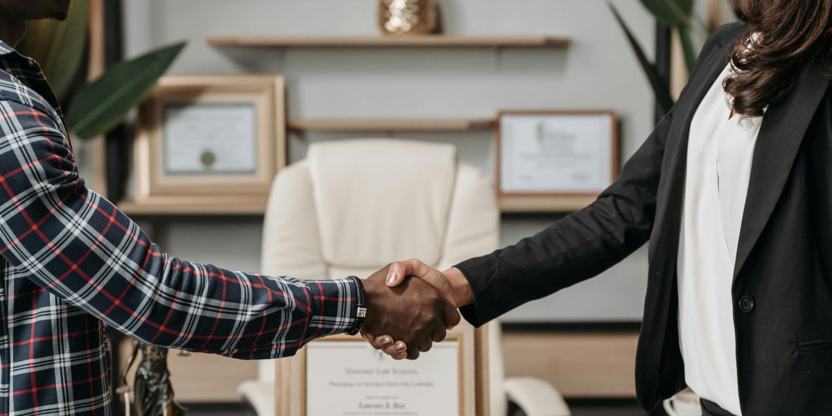 Two professionals shaking hands, symbolizing successful partnerships and strategic alliances in the AI industry.
