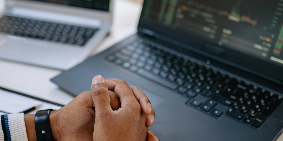 A person meticulously analyzes data, reflecting the importance of observability in maintaining AI system health.