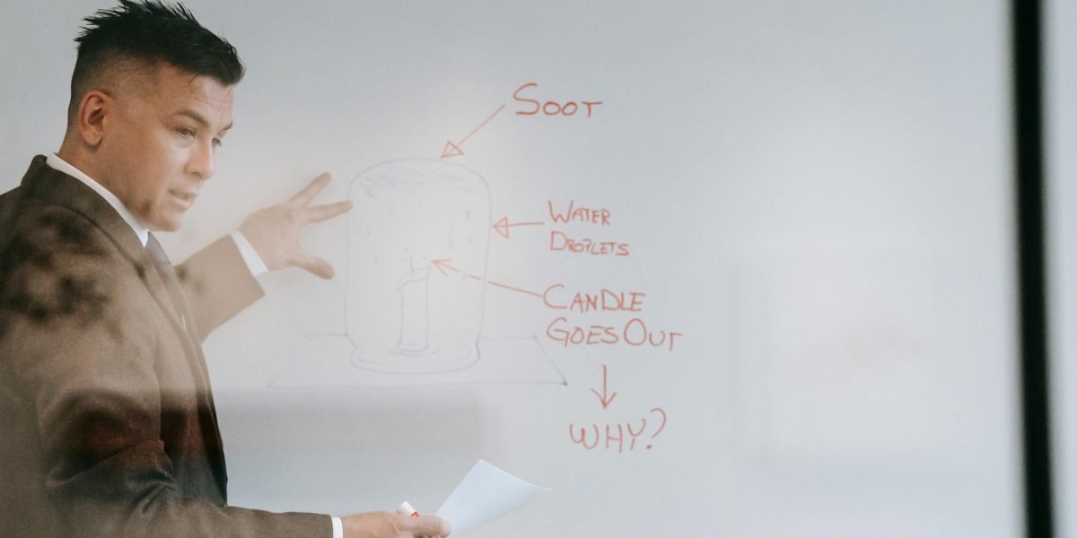 A person clearly explaining complex ideas on a whiteboard, reflecting the importance of mastering and communicating core data science skills.