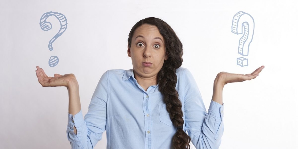 A person appears thoughtful while contemplating multiple options or making a crucial decision, reflecting the challenge of selecting the right AI tool.