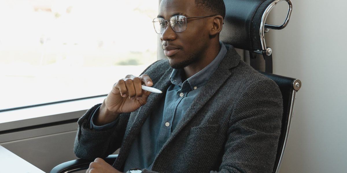 A business leader deep in thought, considering the strategic impact of new AI technologies on their organization.