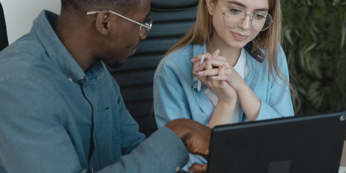 An experienced mentor guiding a new employee, illustrating the importance of training and calibration in data annotation.
