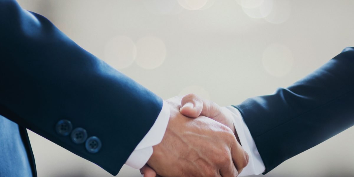 A professional handshake symbolizing a successful business partnership and achieved ROI through AI integration.
