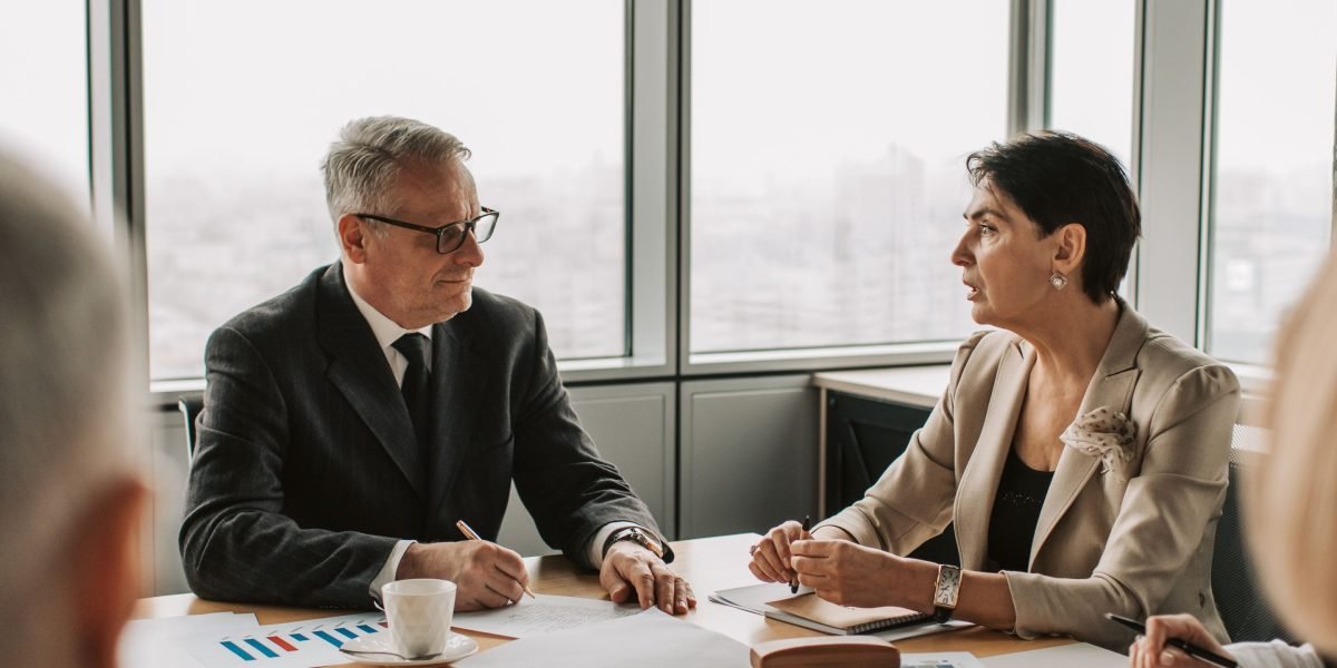 Professionals engage in a strategic meeting, discussing investment decisions and AI implementation.