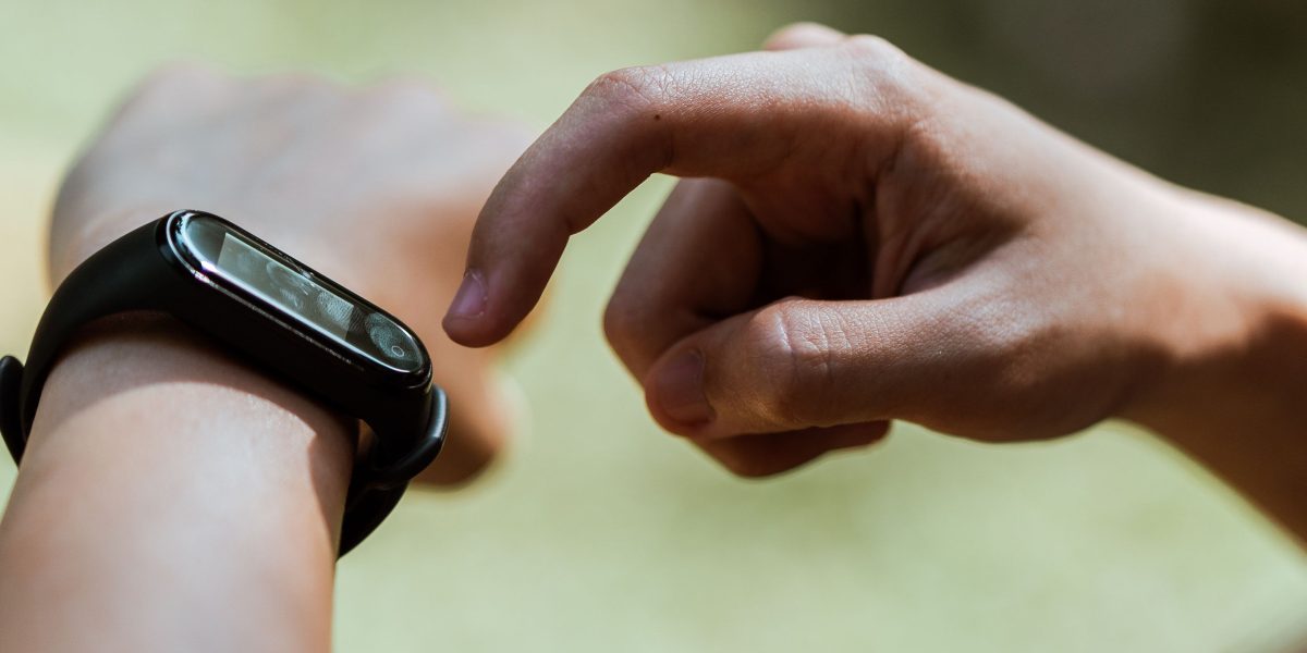 A person checking health data on a smartwatch, illustrating the privacy and immediacy of edge AI in personal healthcare.