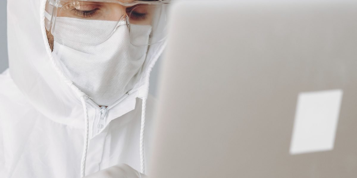 An individual thoughtfully reviewing documents or digital information, emphasizing the importance of data security.
