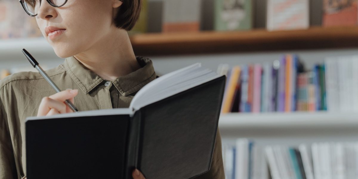 A person thoughtfully considering various learning paths, such as courses, certifications, or degree programs for mastering AI.
