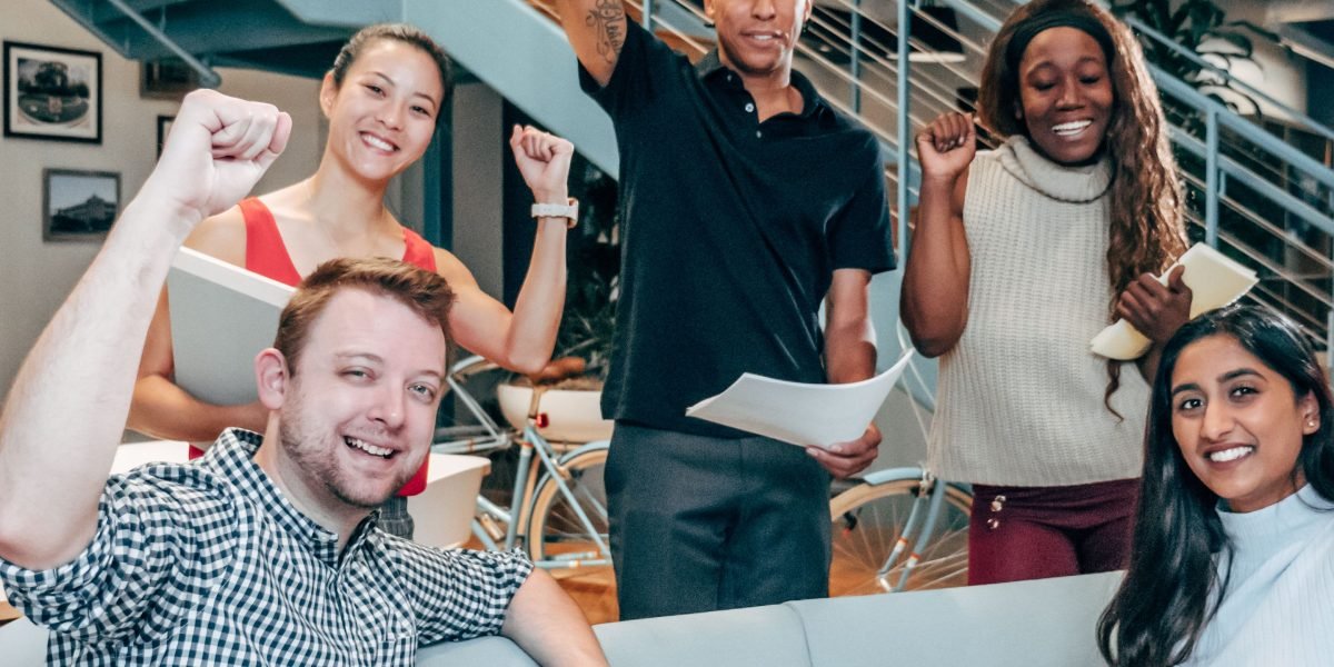 A diverse team actively collaborating in an office setting, representing enhanced productivity through AI augmentation.