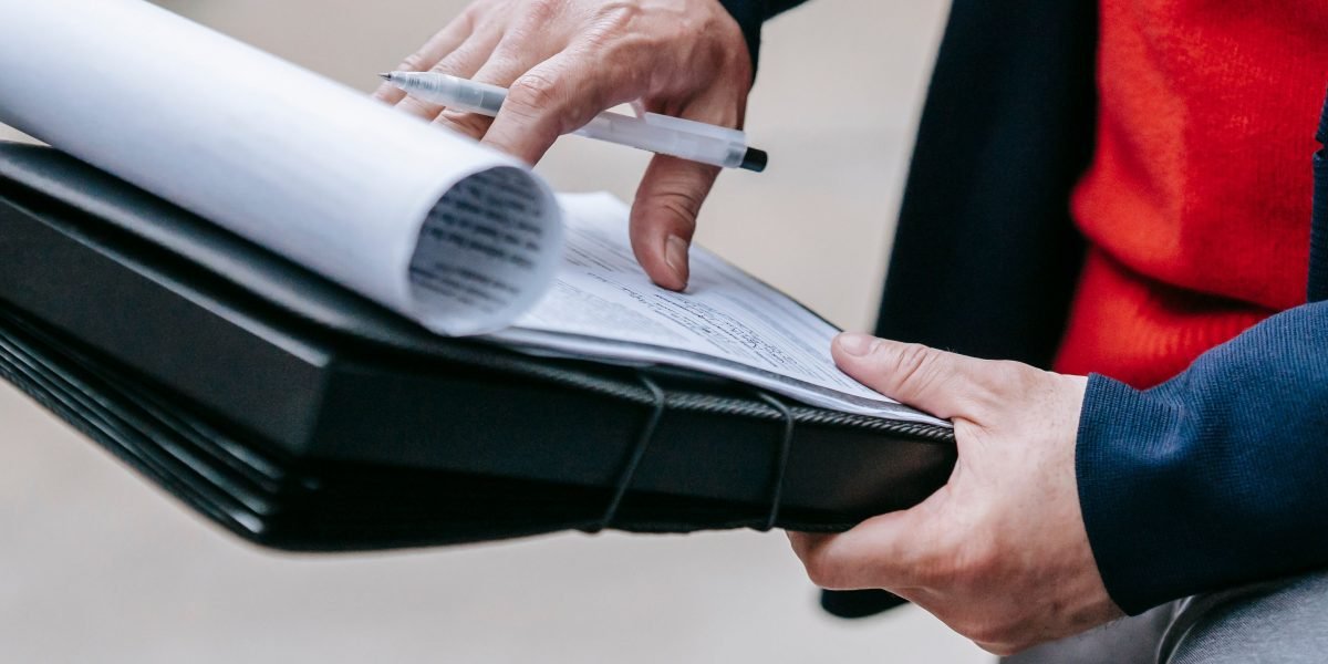 A person focused on reviewing a document with a critical eye, emphasizing human oversight in AI workflows.