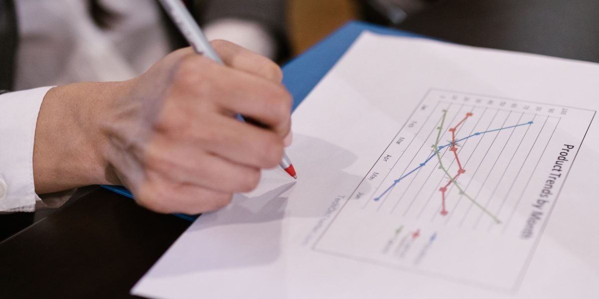 A professional analyzing a business report, representing the evaluation of performance metrics and ROI.