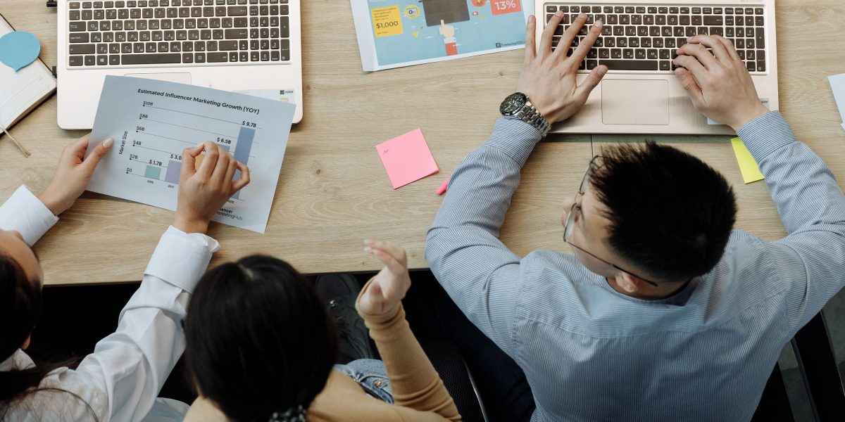 A diverse team of professionals collaborating effectively on a data analysis project in a modern office environment.