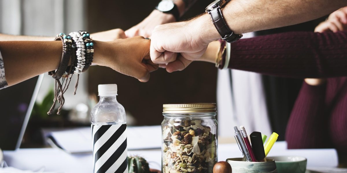 A team collaborating around a table, symbolizing smart decision-making facilitated by AI-powered insights and task assignment.