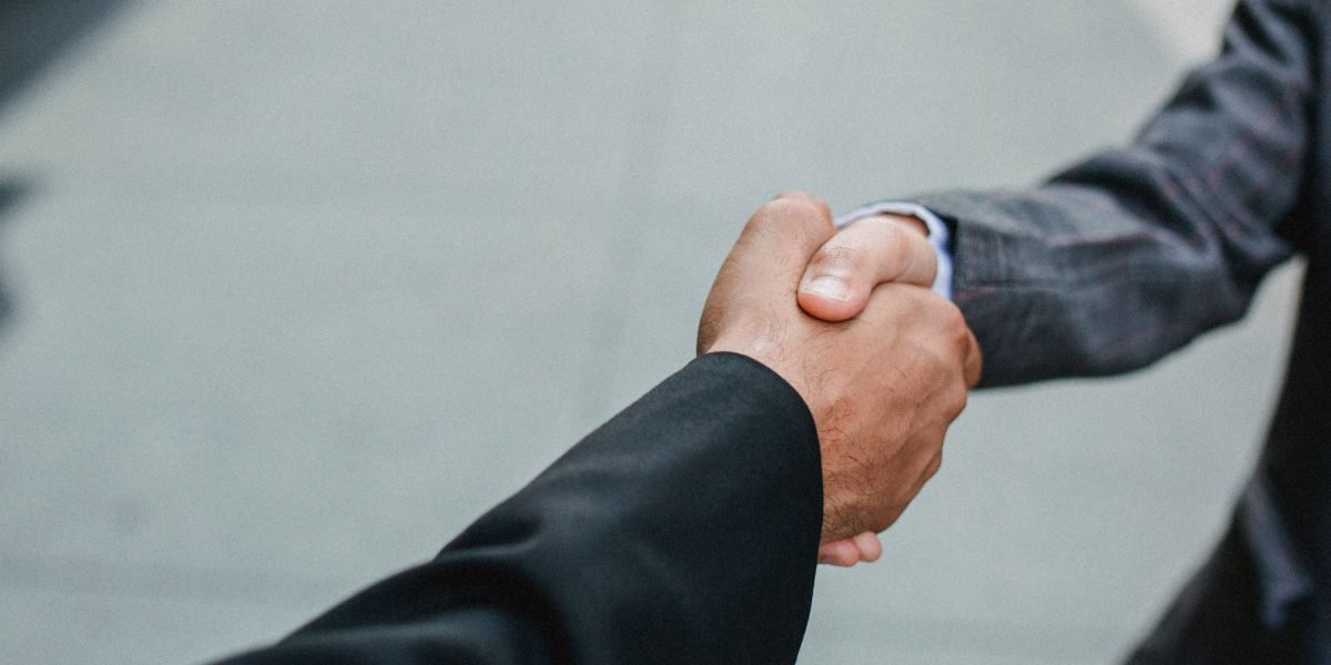 Professionals conclude a successful meeting, symbolizing positive career outcomes after acquiring new skills.