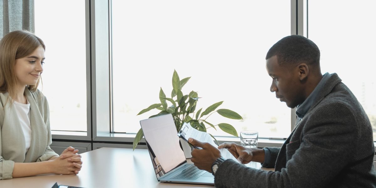 A person confidently engaging in a job interview, symbolizing the final step in a career transition.