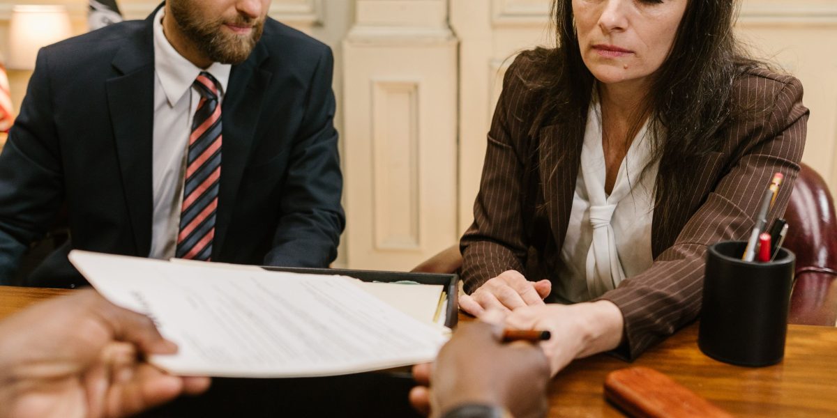 Professionals discuss documents, emphasizing the importance of reviewing privacy policies and consent.