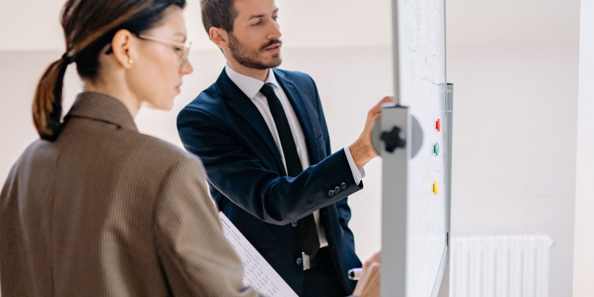 A team actively collaborating around a whiteboard, representing the collective effort in building and optimizing AI analytics pipelines.