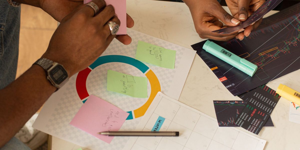 A team collaborates on a whiteboard, strategizing how to scale their newsletter with AI for personalized audience growth.