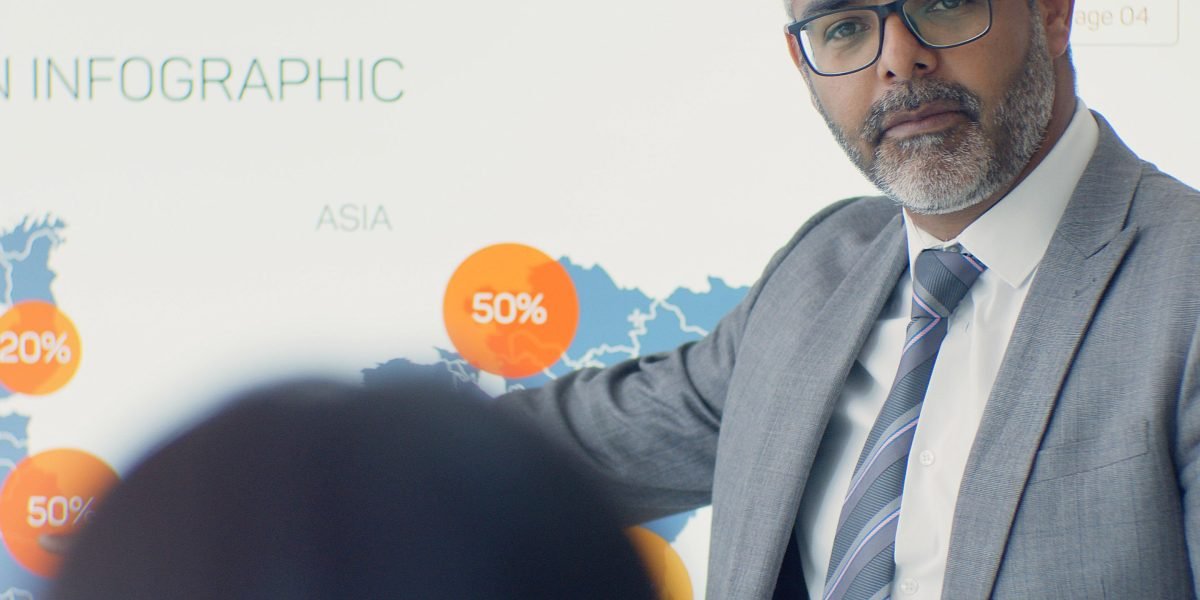 An executive confidently presenting findings on business performance and AI project outcomes.