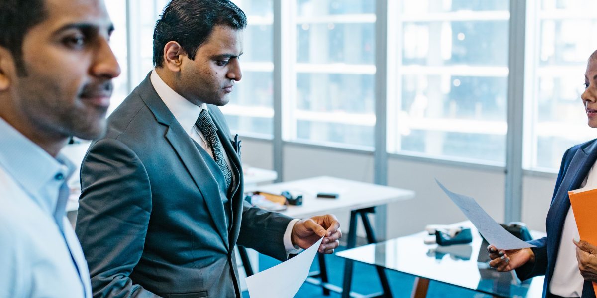 Business professionals engage in a serious discussion about the ethical implications of AI technology.