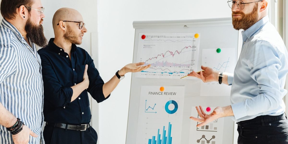 A team of marketing professionals collaborating and discussing strategy at a whiteboard, reflecting smart targeting and personalization efforts.