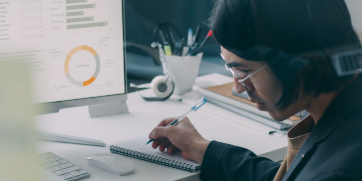 A business professional meticulously reviewing a report, symbolizing the crucial process of measuring ROI and campaign impact.